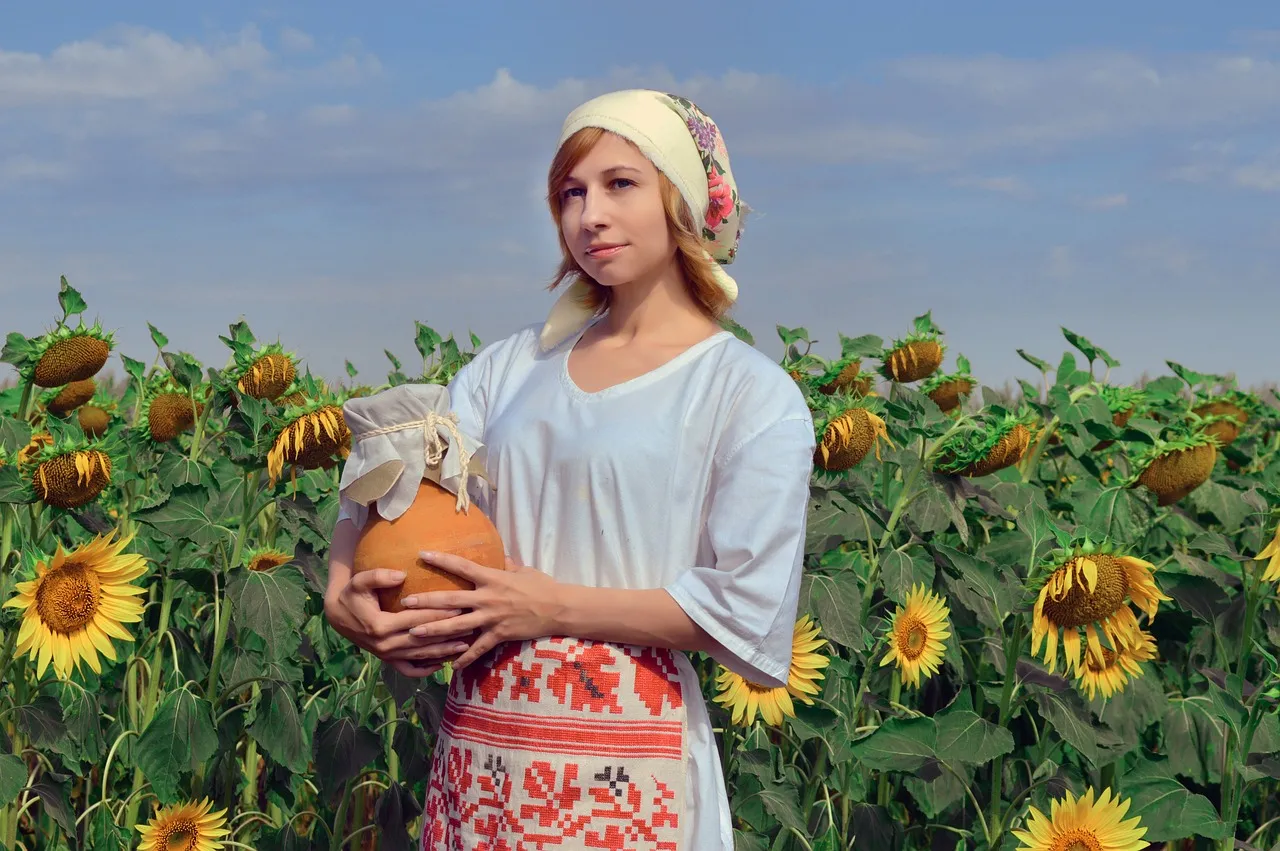 Femme ukrainienne en costume traditionnel dans un champ de tournesols